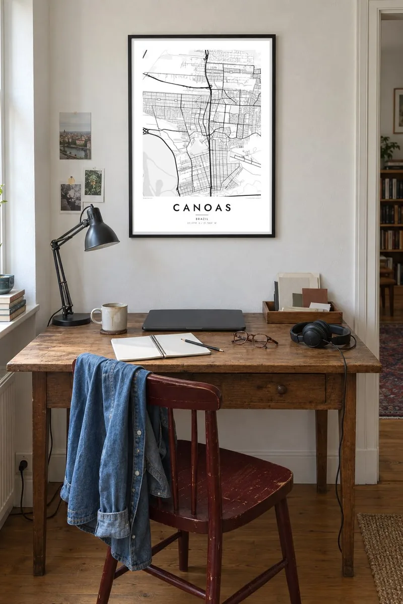 Canoas map poster in a black frame, creative desk interior